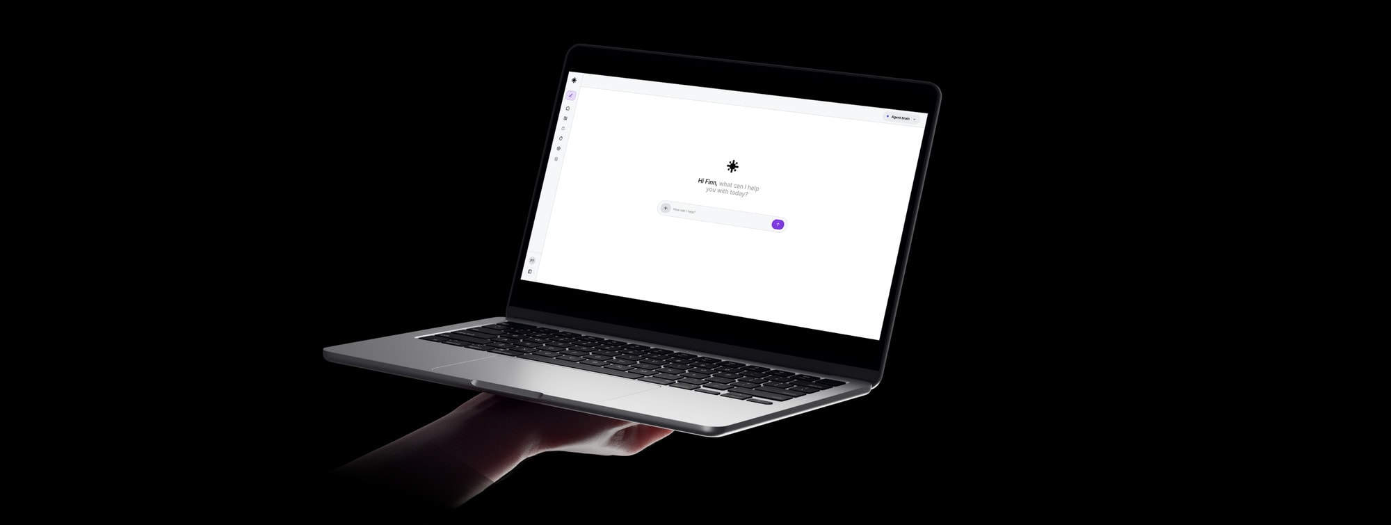 The HarmonIQ prompt screen on a laptop, held in one hand against black.